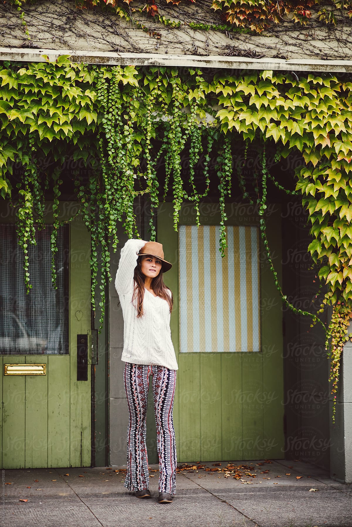 Beautiful Young Woman Dressed Stylishly Standing In Ivy Doorway By Stocksy Contributor Kate 4025