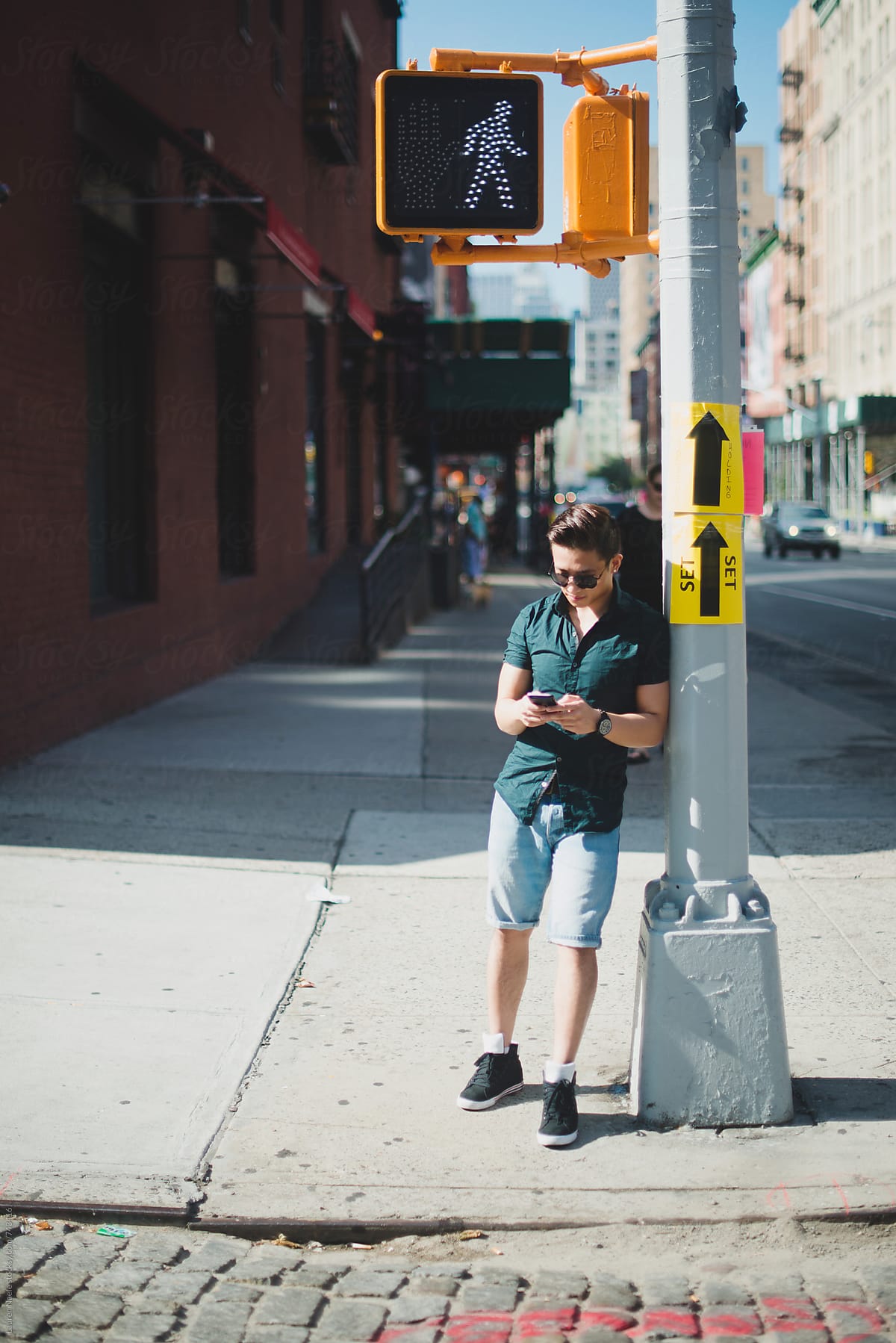 Man texting while standing in New York City street