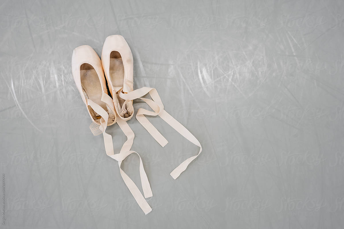 Top view of pointe shoes on dance studio floor