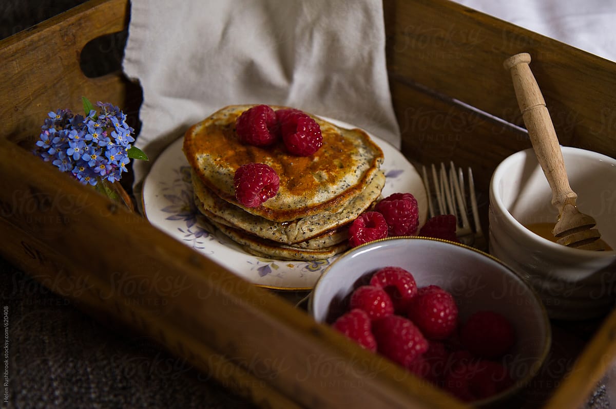 A breakfast tray of pancakes and raspberries
