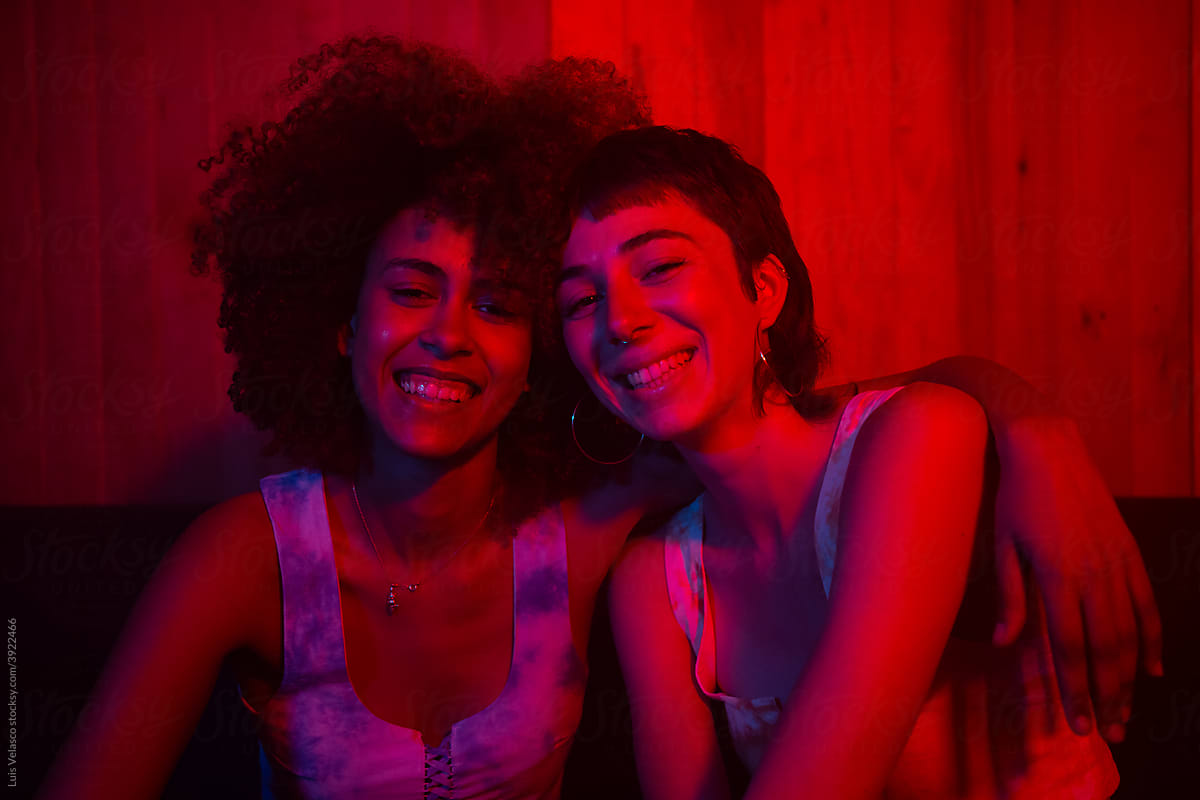 Happy Couple Of Stylish Young Girls With Red Lights.