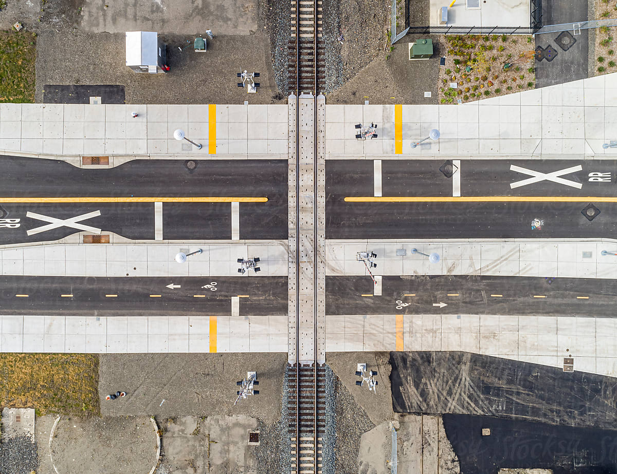 Aerial drone bird\'s eye view of a railroad crossing
