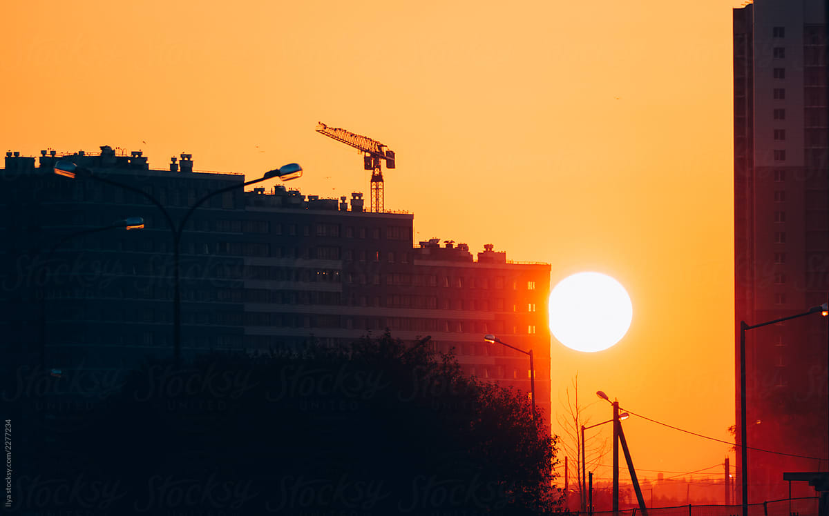 Construction site and crane on sunset