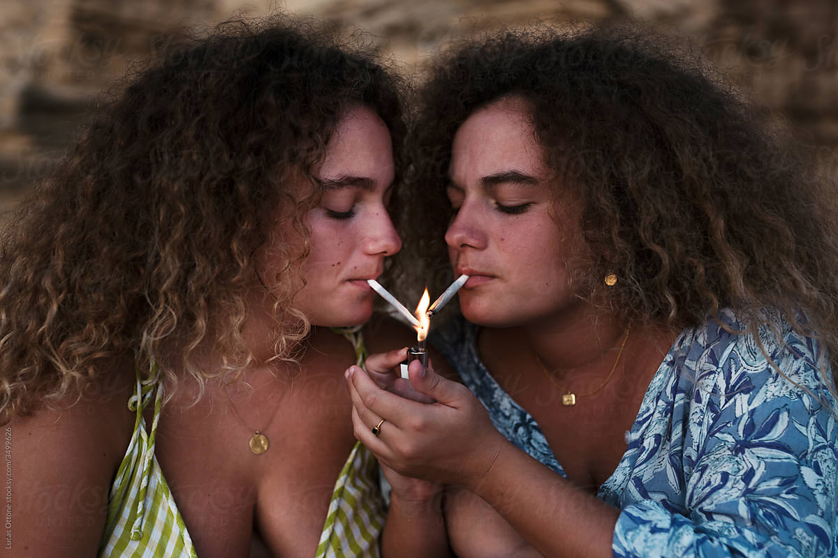 Twin Sisters Lighting A Cigarette