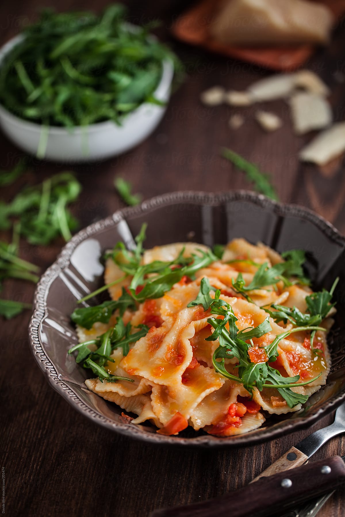 Pasta with tomato sauce and rocket salad