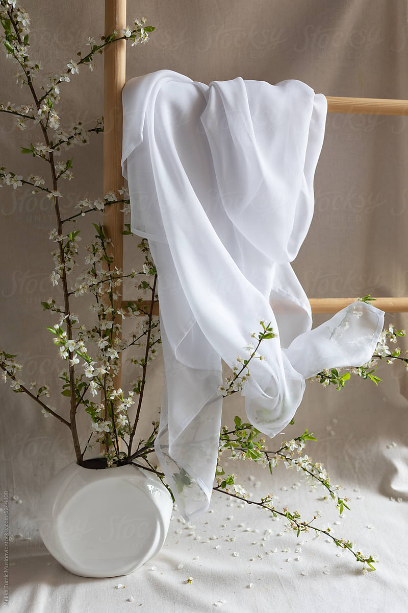 Silk white scarf on wooden rack