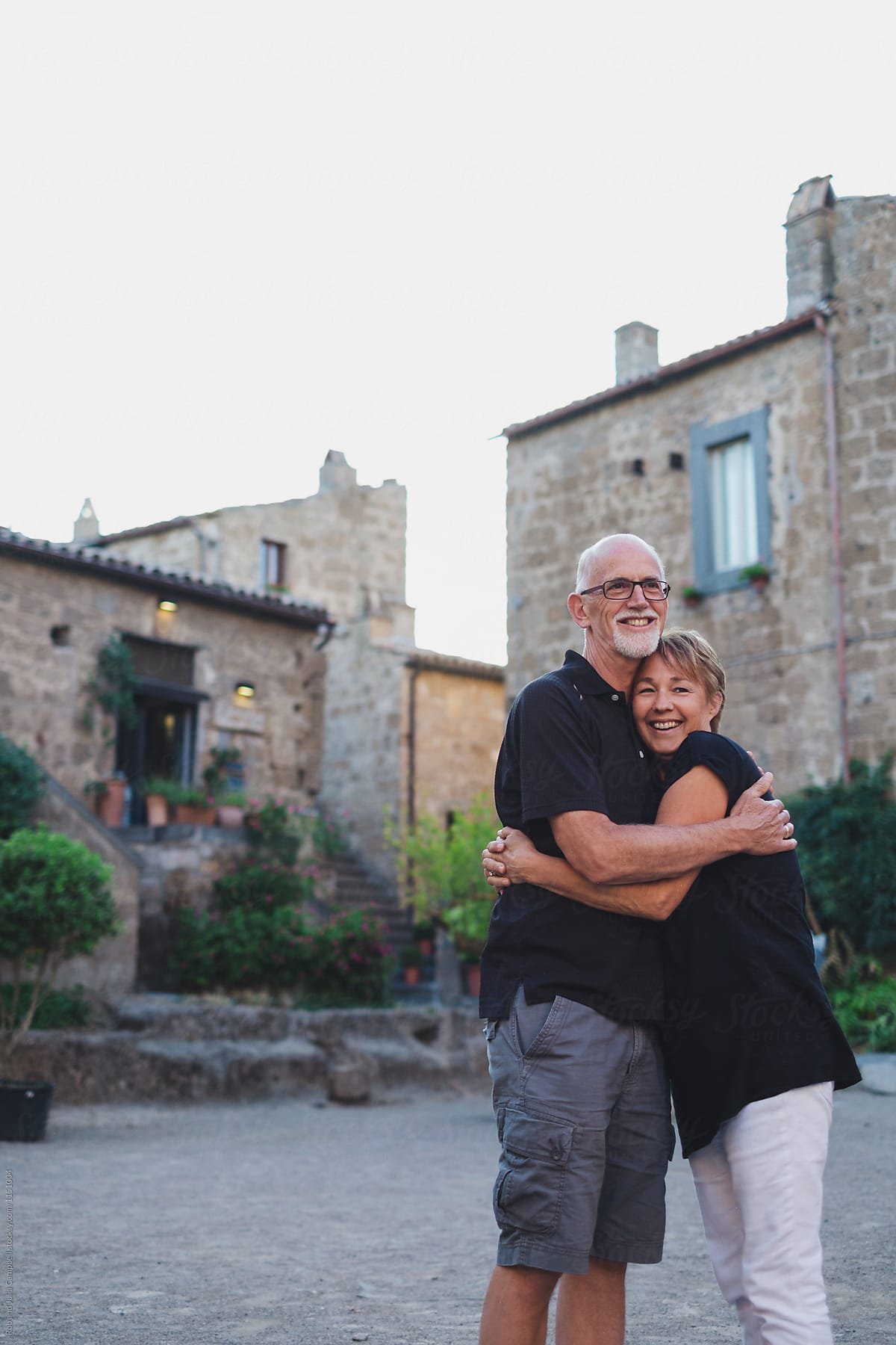 Happy middle age couple together in old Tuscan town