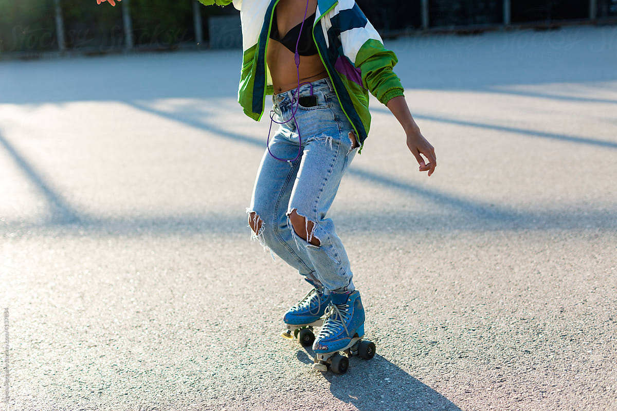 Unrecognizable Roller-skater body training in sunlight