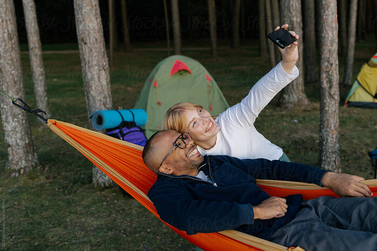 A man and woman are photographed in camping