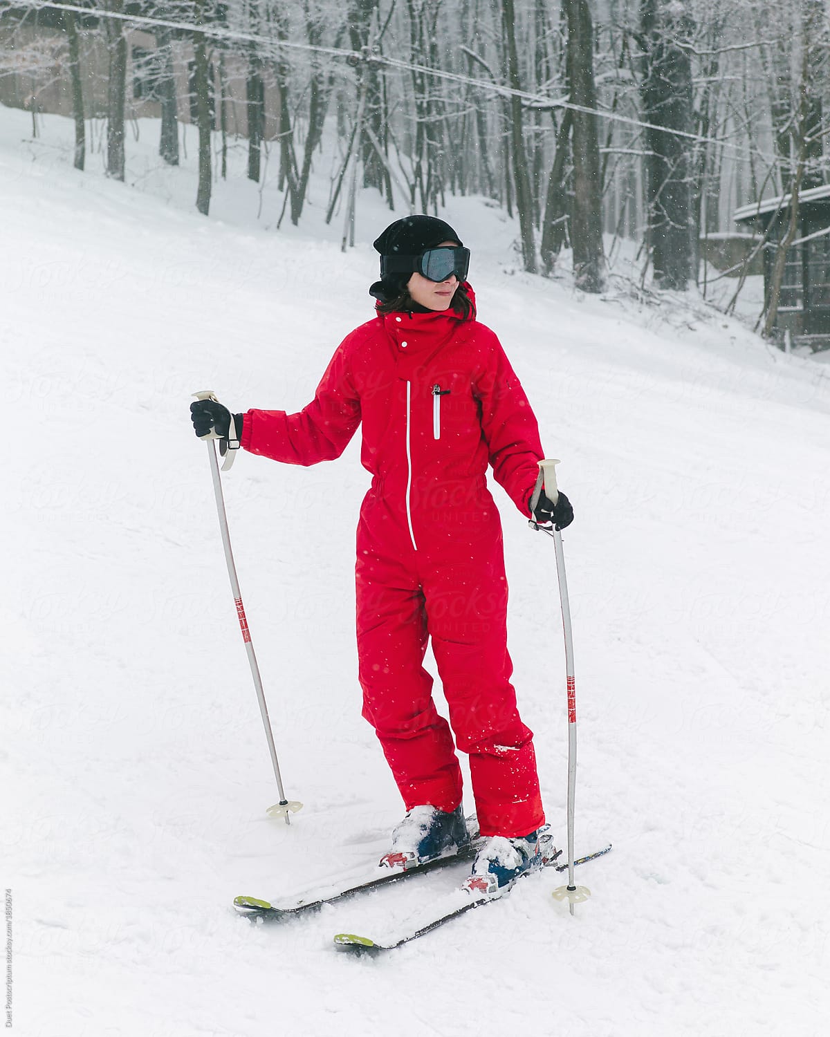 Woman in glasses with ski and sticks