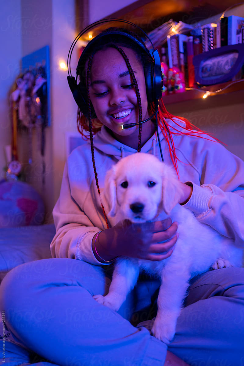Teen Black Girl With Her Little Dog In Her Bedroom.