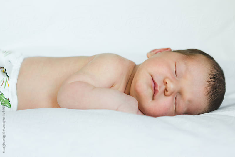 Newborn Baby Girl Sleeping on Soft White