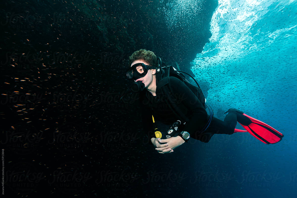 Portret of a gen-z boy scuba diving