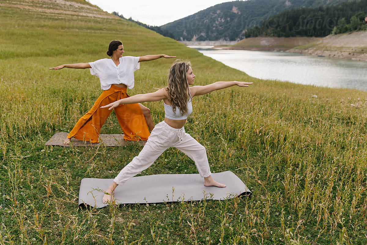 Two Women In A Warrior Yoga Pose