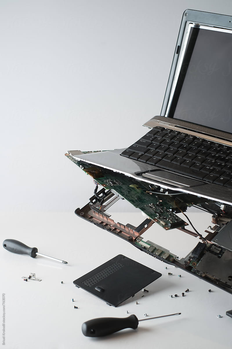 Close Up Of Broken Dark Gray Laptop With Tools