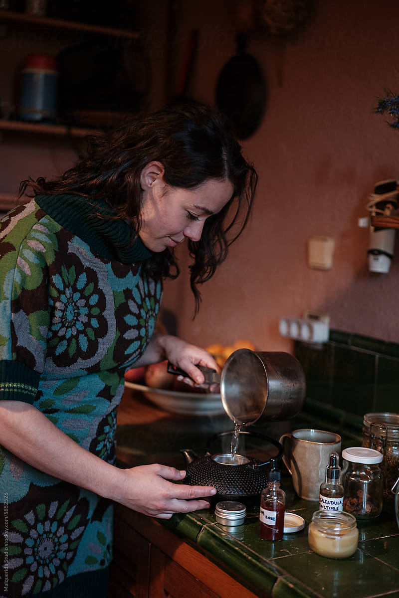 Woman preparing tea on teapot