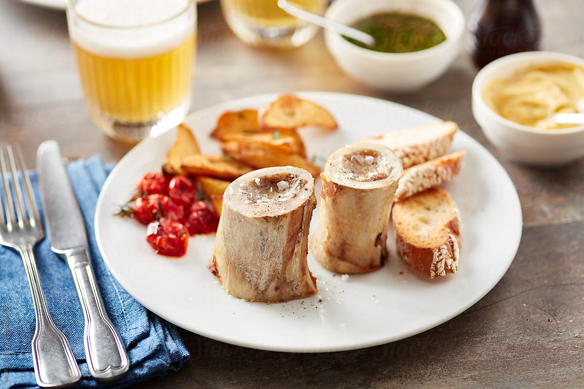Marrow bones served with toasts, potato and tomatoes.