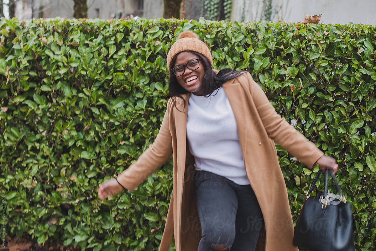 happy black woman laughing on the street