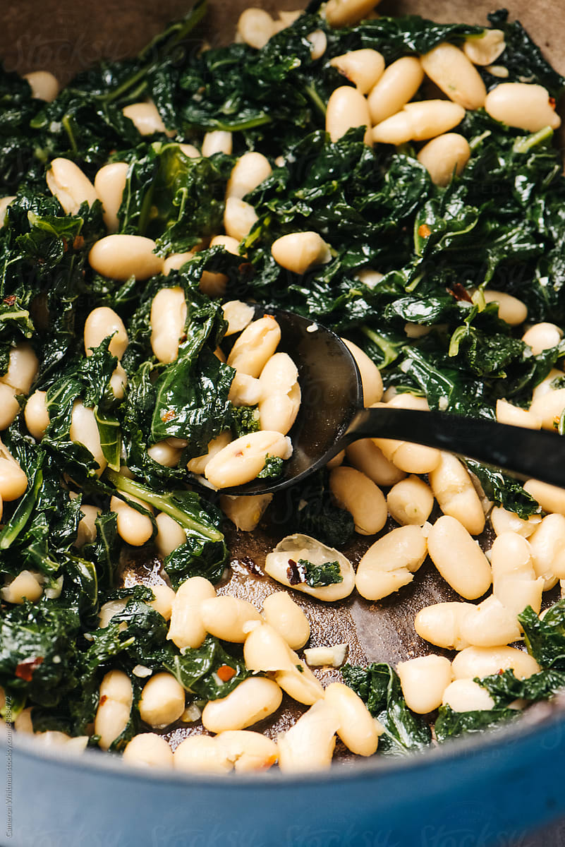 Tuscan beans and greens cooked in a Dutch oven