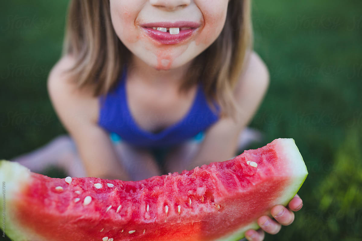 7 year old eating a juicy watermelon slice