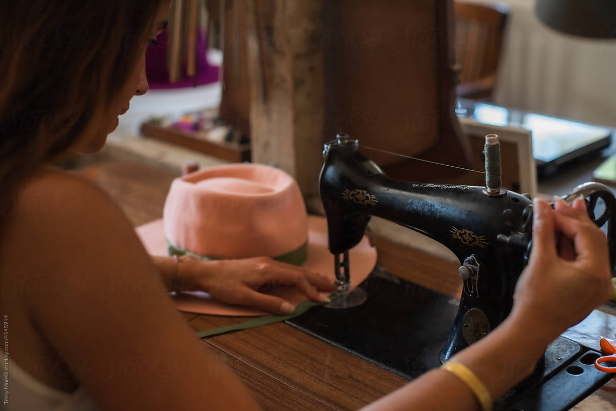 Designer at work on the antique sewing machine