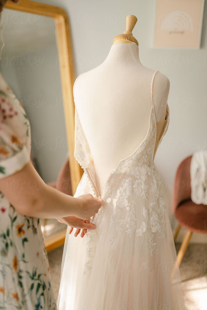 seamstress working on  a wedding dress