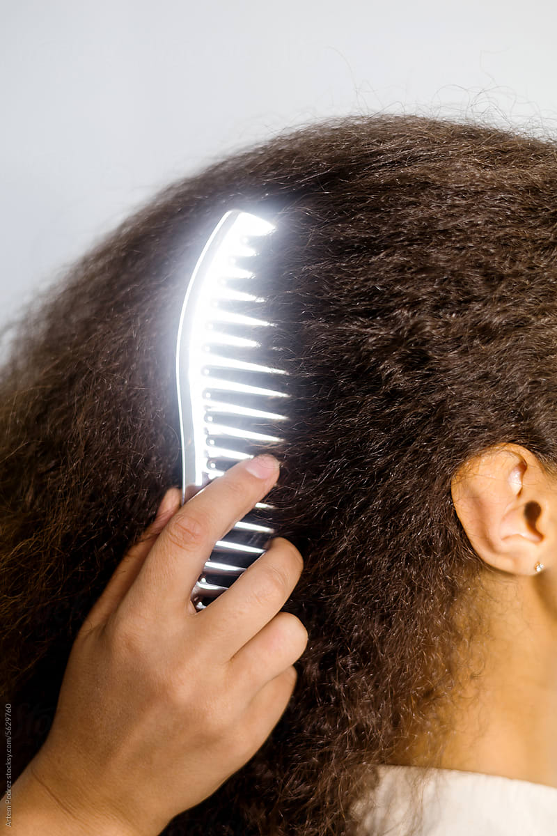 Professional Stylist Combing Woman Curly Hair