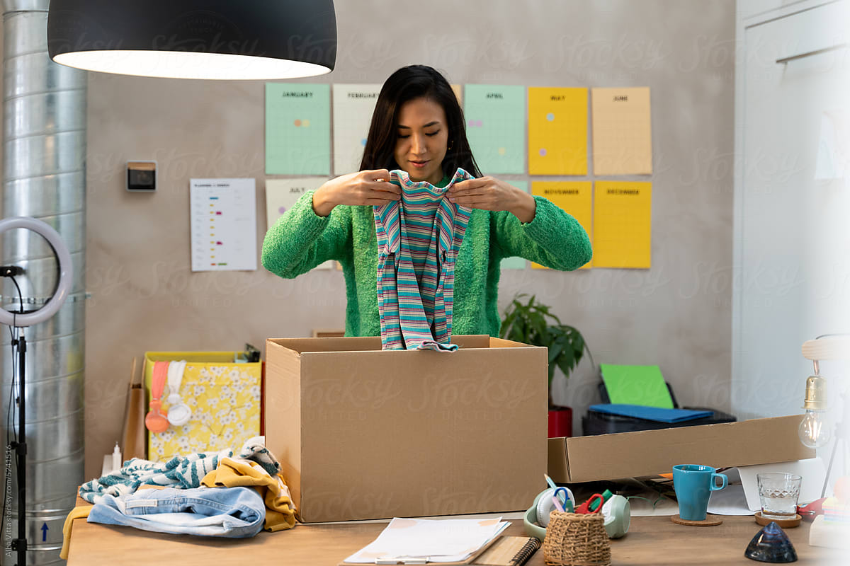 Woman packing clothes at home