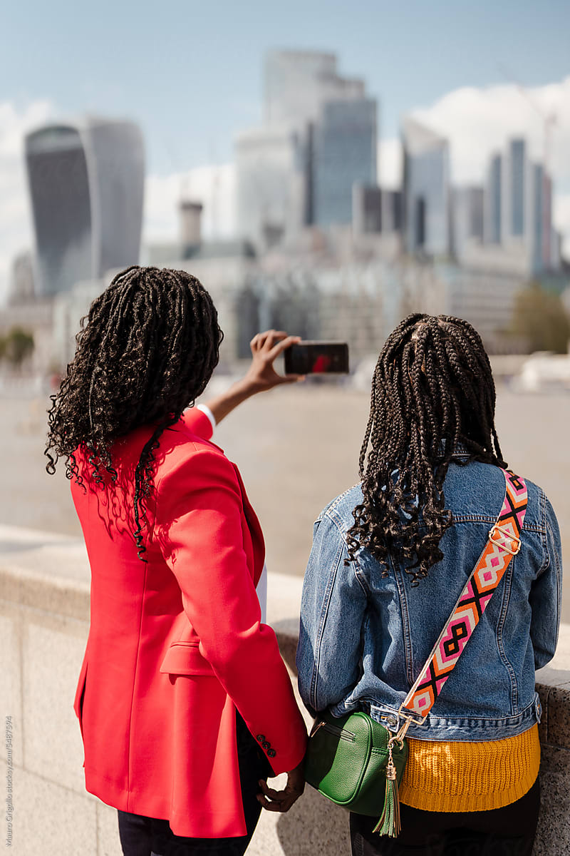 Women taking photos in the city