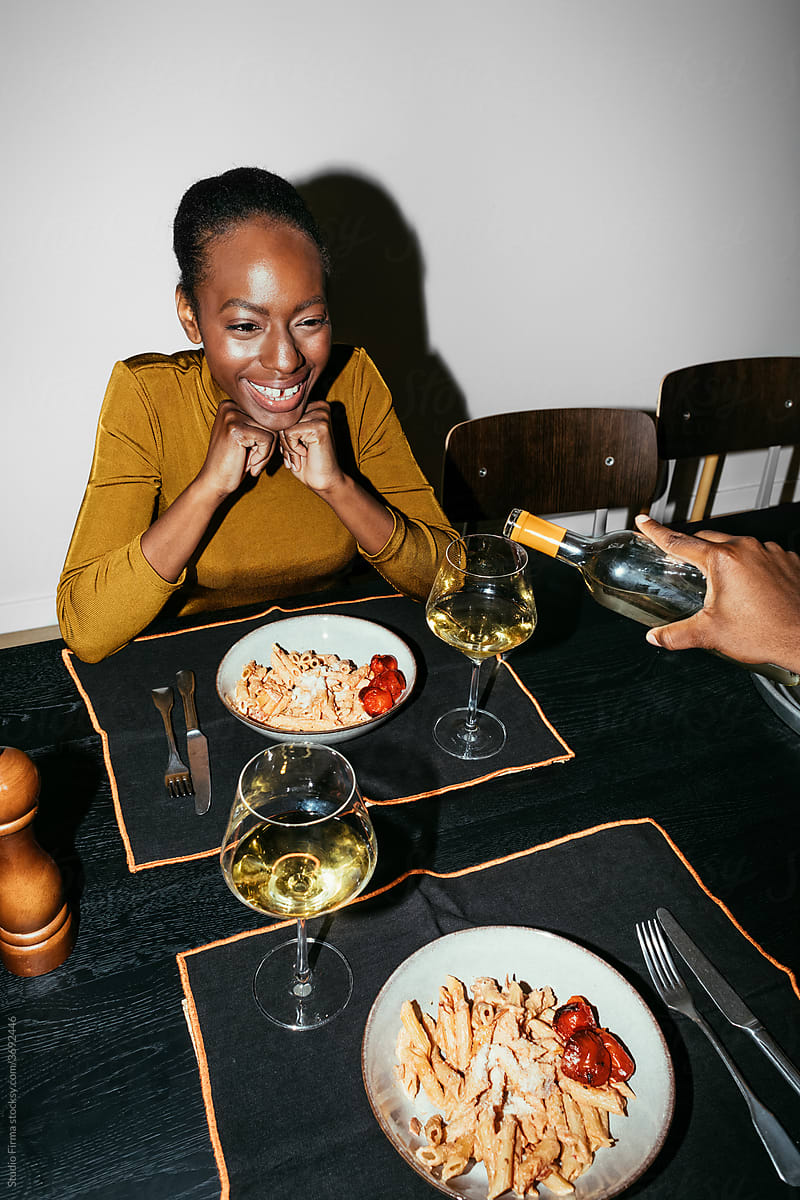 A Woman Having Dinner and Drinking Wine with a Man