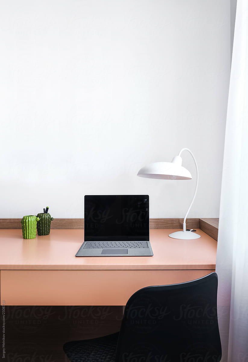 Laptop on table with lamp