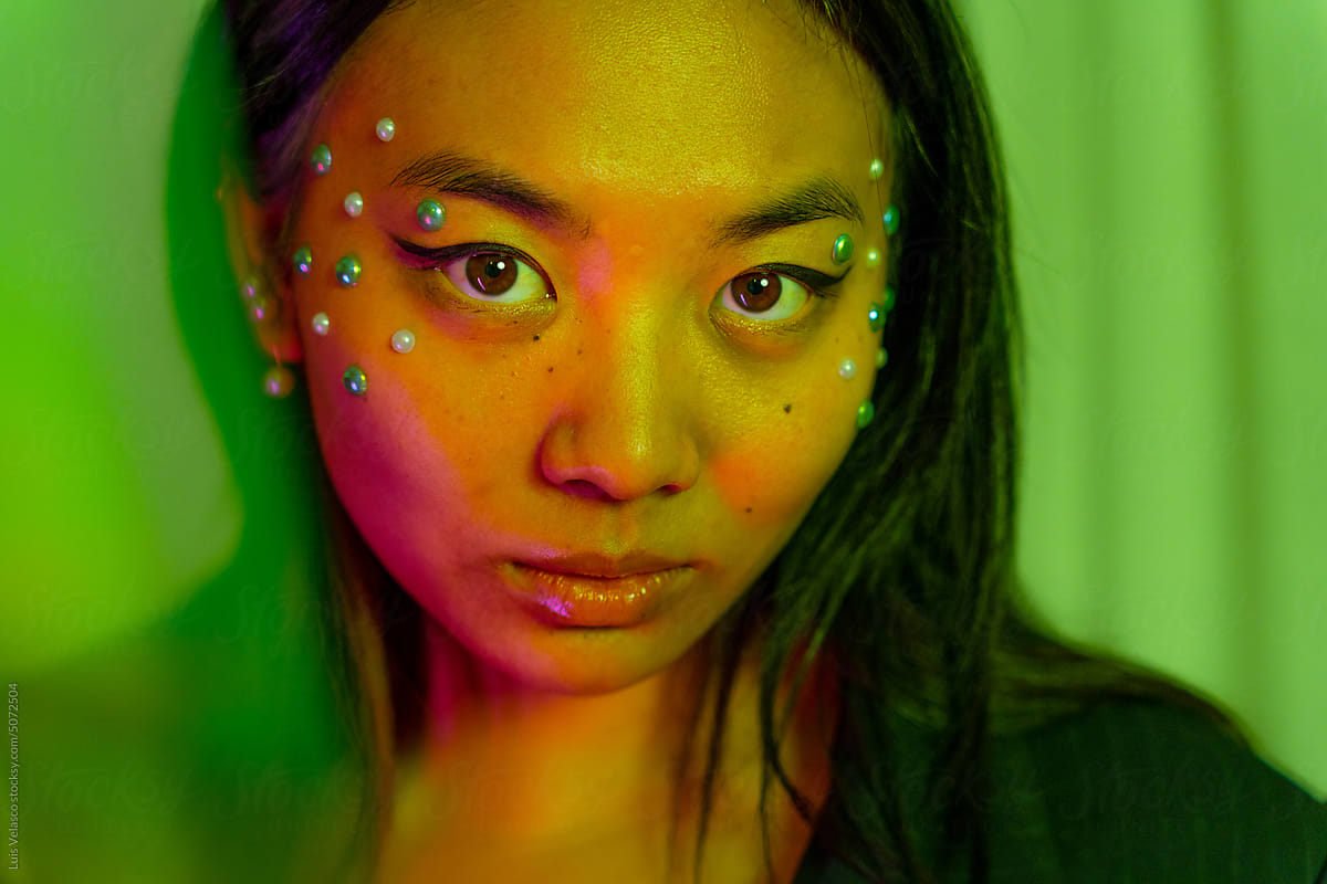 Green And Orange Portrait Of An Asian Woman.