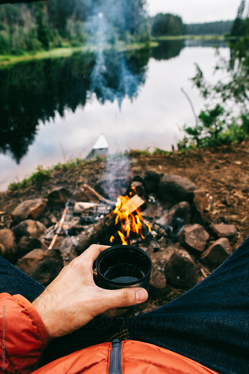 Anonymous Man Drinking Tea by Campfire