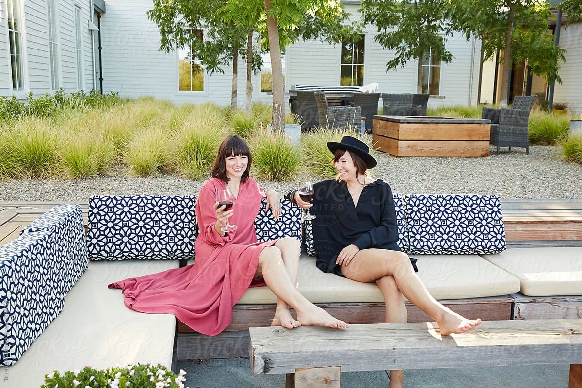 Friends Lounging With Wine On Backyard Patio By Stocksy Contributor 