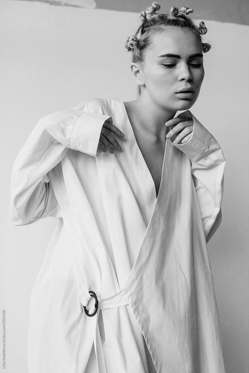 Monochrome portrait of stylish model wearing white long shirt