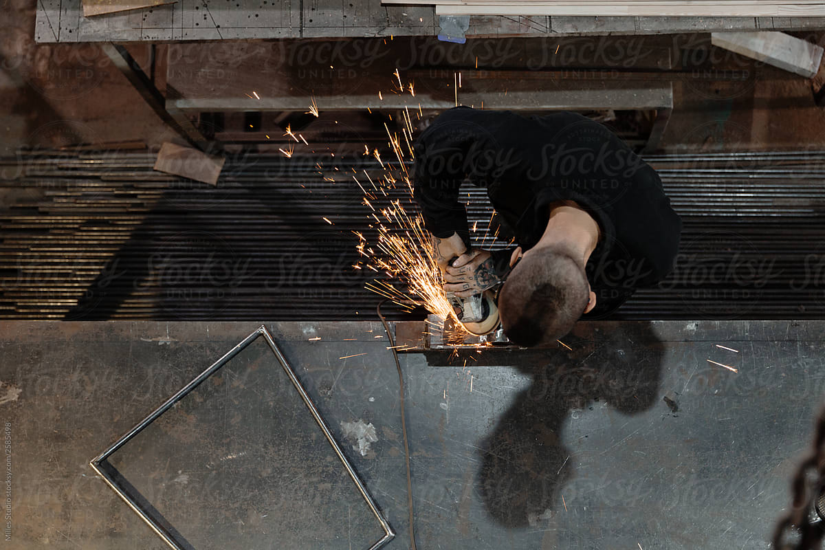 Metalworker creating iron construction in workshop
