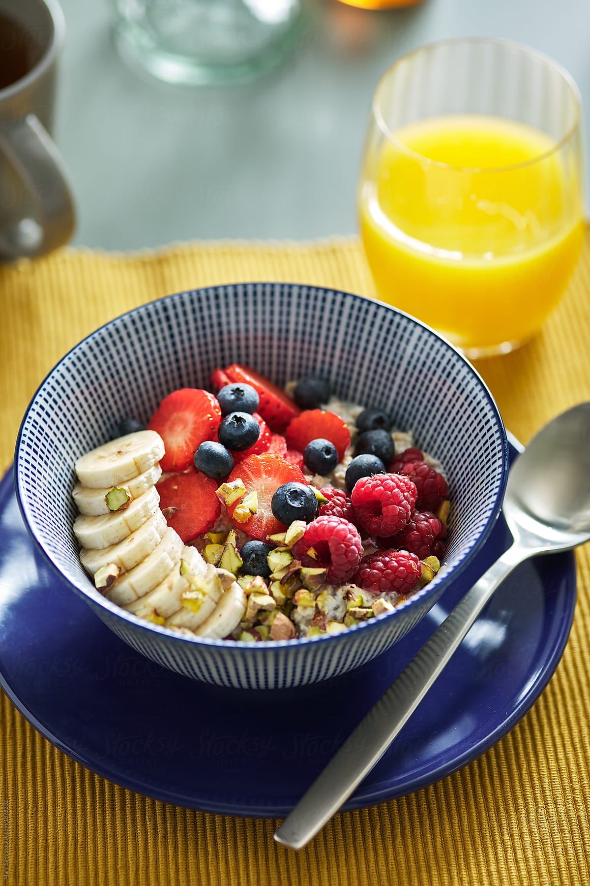 Delicious porridge with fruit and berries in bowl.