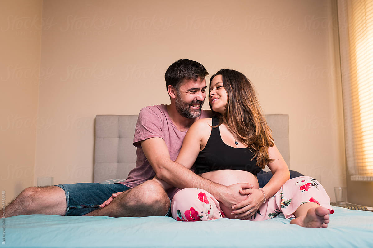 Happy couple enjoying pregnancy at home