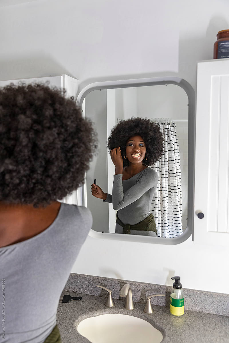 Black Lifestyle Girl  bathroom looking applying mascara makeup eye