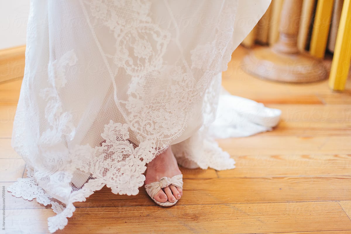 Bride Putting on Shoes on her Wedding Day