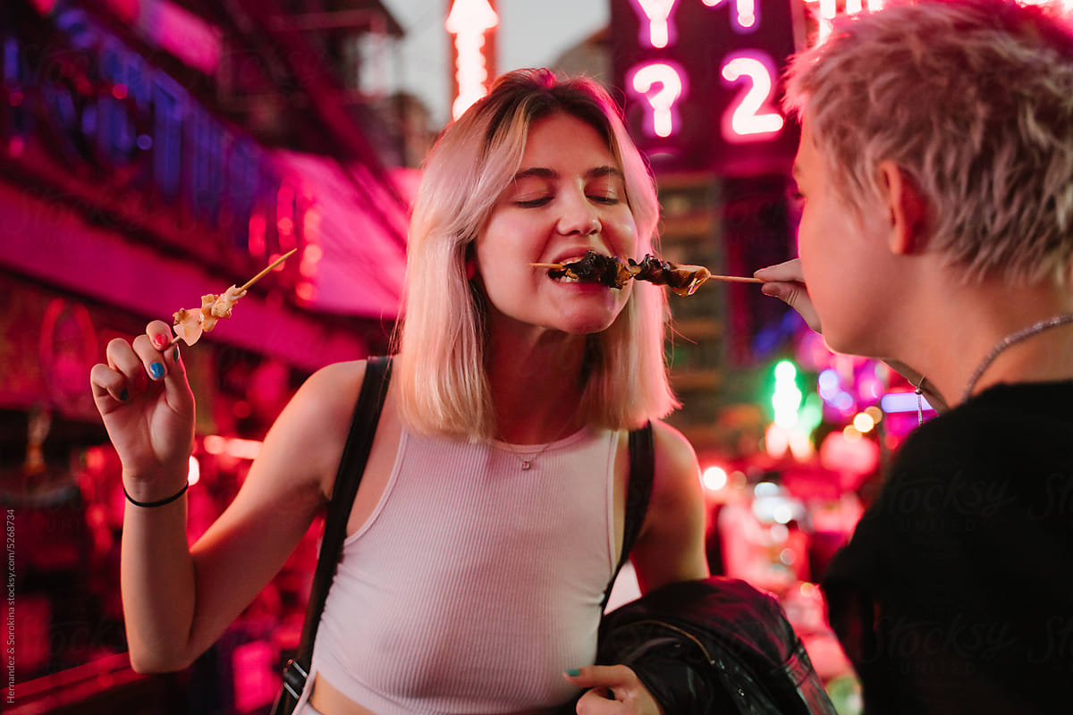 Two Woman Eating Street Food In Bangkok Street