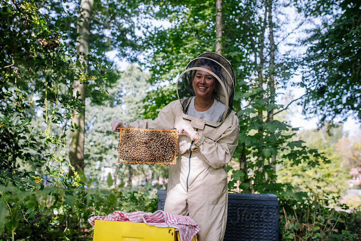Portrait of a female beekeeper, showing her bees