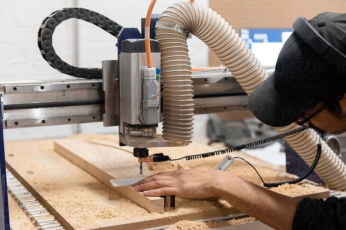 Craftsman cutting wood with a CNC wood router