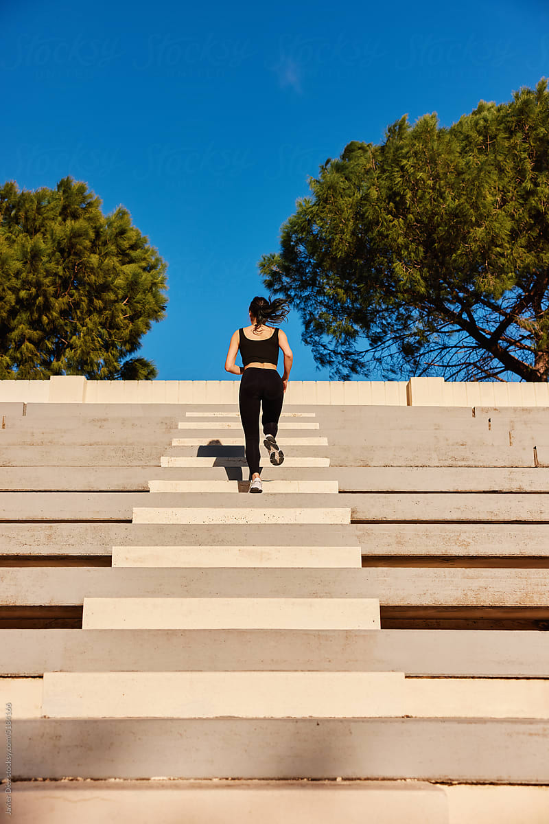 Sportswoman running on arena steps