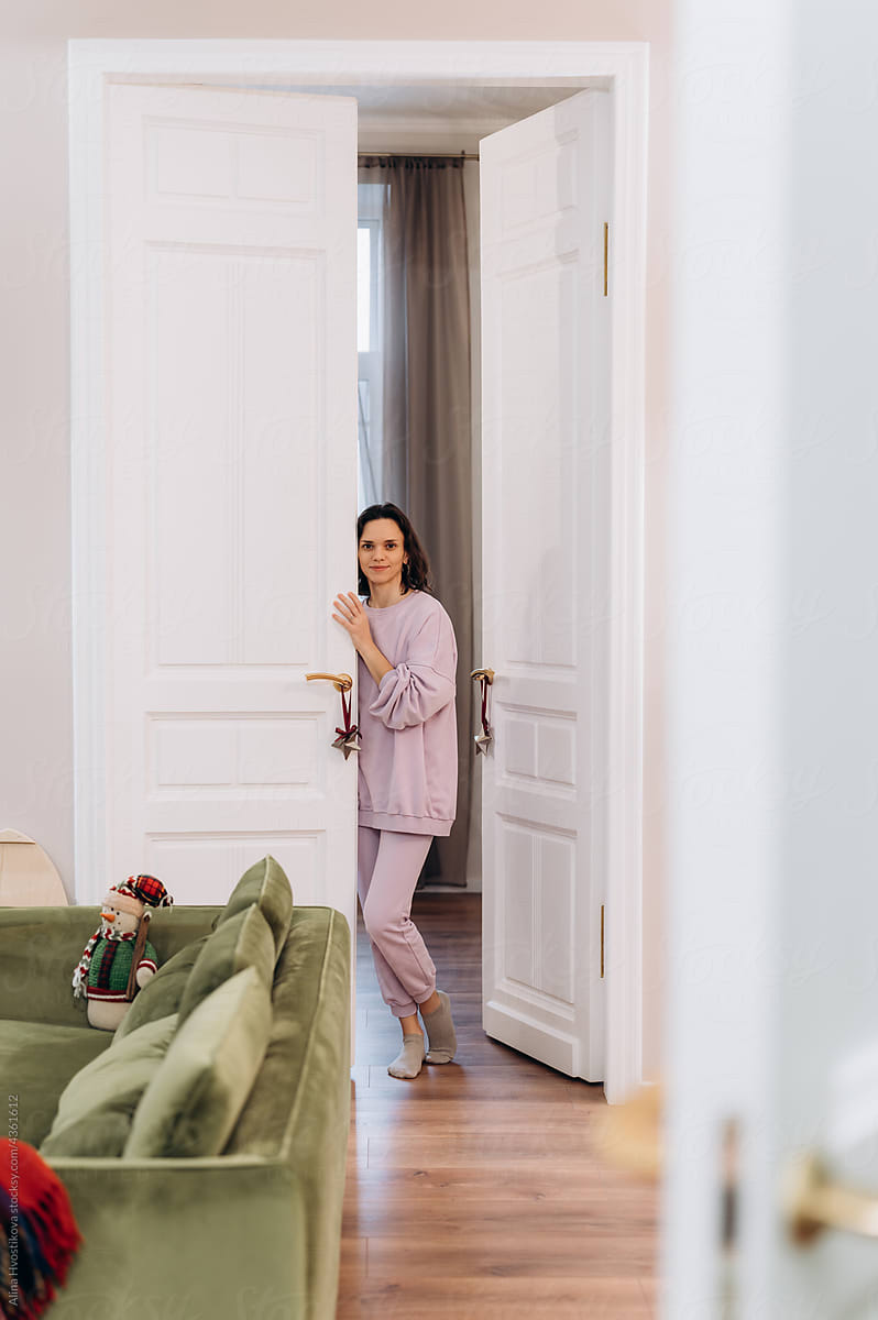 Woman standing in doorway of room