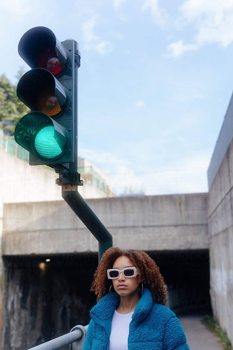 Woman walking near a traffic light