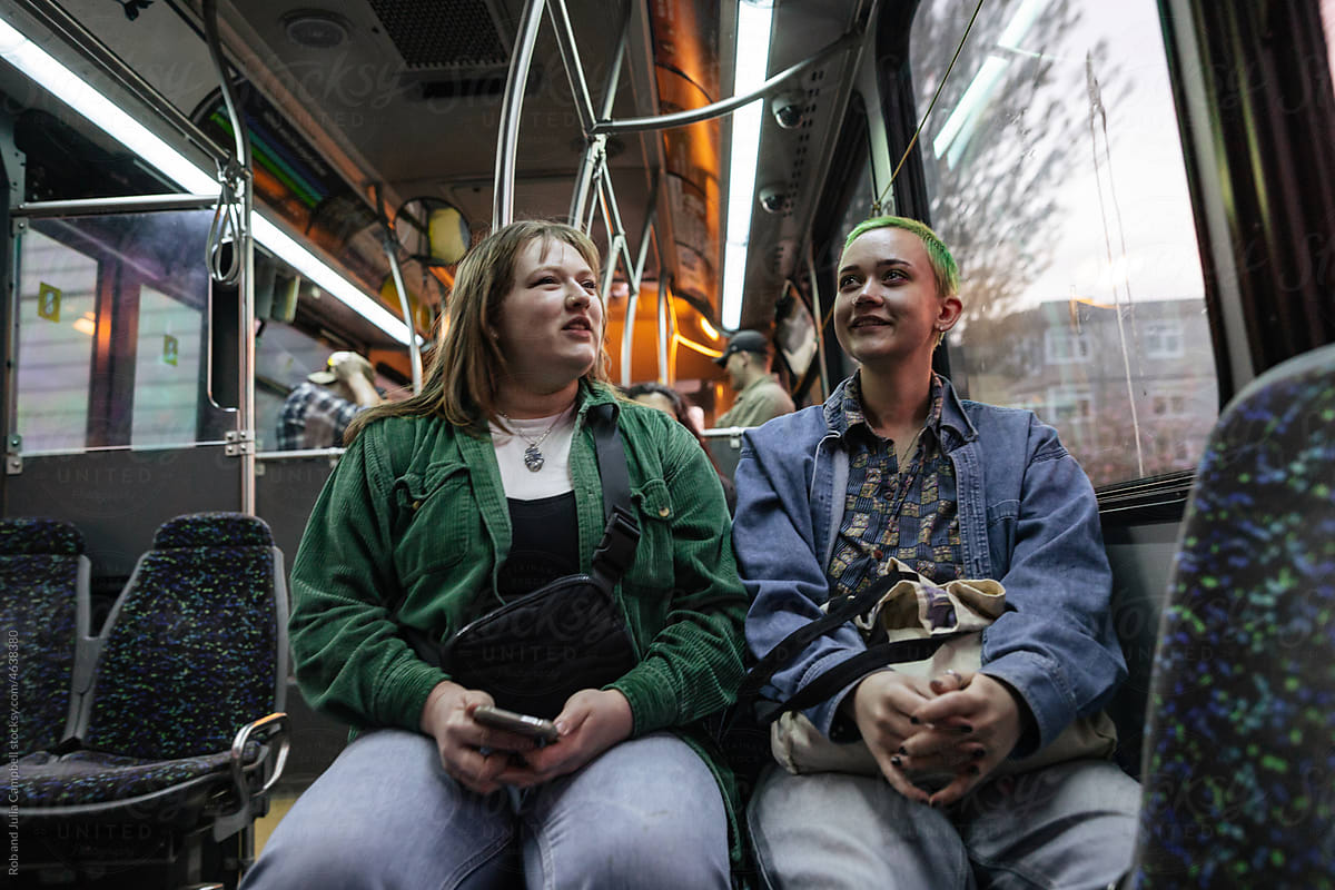 Young people riding the bus in the evening.