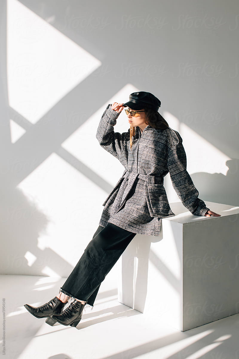 Stylish woman in autumn outfit in studio