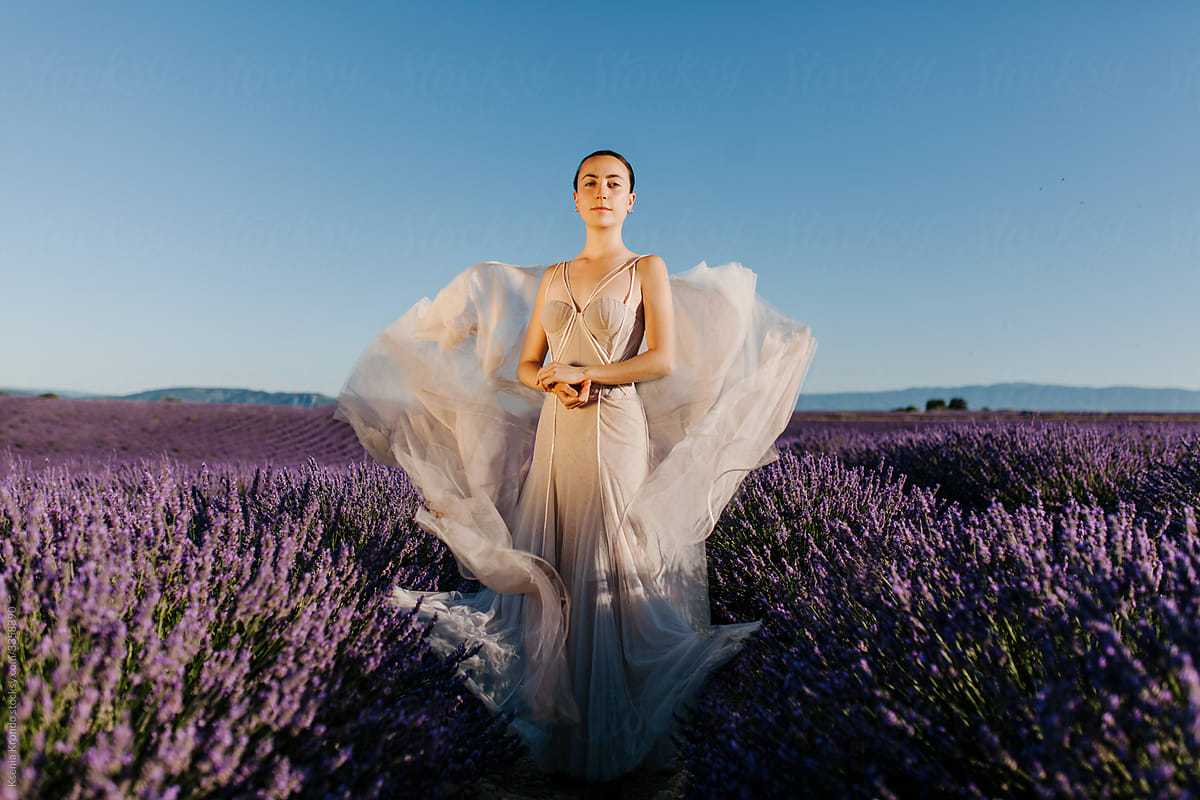 Girl at the lavender field standing posing long wedding dress gown brunette