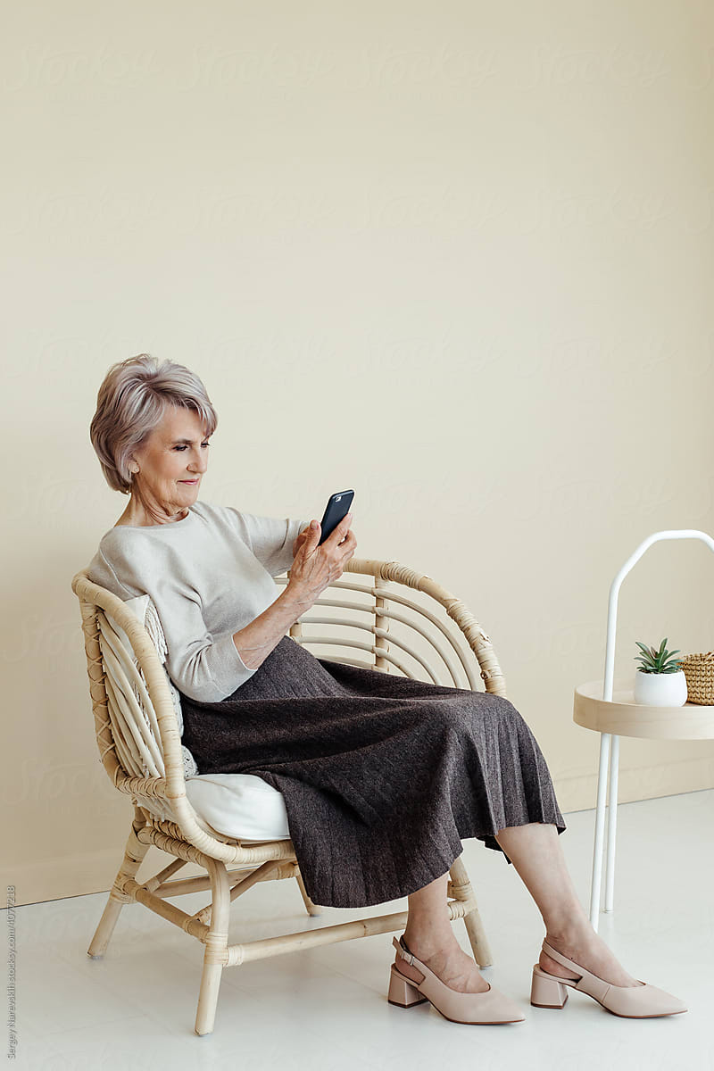 Senior woman reading on smartphone